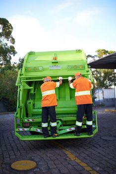 Cropped shot of a garbage collection team at work.