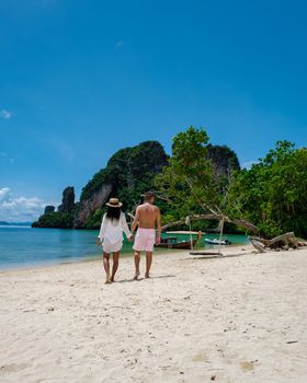 Koh Phakbia Island is near Koh Hong Krabi, a beautiful white sandy beach in Krabi Thailand. Young Asian woman and European men on the beach.