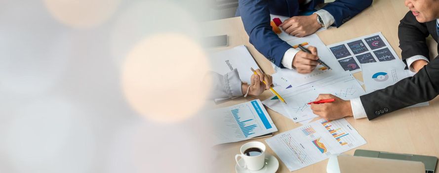 Smart businessman and businesswoman talking discussion in widen group meeting at office table in a modern office interior. Business collaboration strategic planning and brainstorming of coworkers.