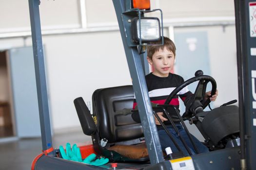 The boy controls the loader. The child chooses a profession.