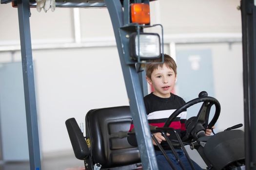 The boy controls the loader. The child chooses a profession.