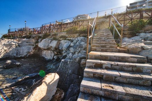 Steps leading up from a rocky beach inlet