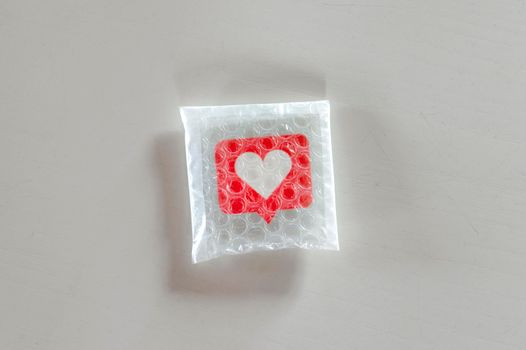 Packaging social symbols and icons with bubble wrap.