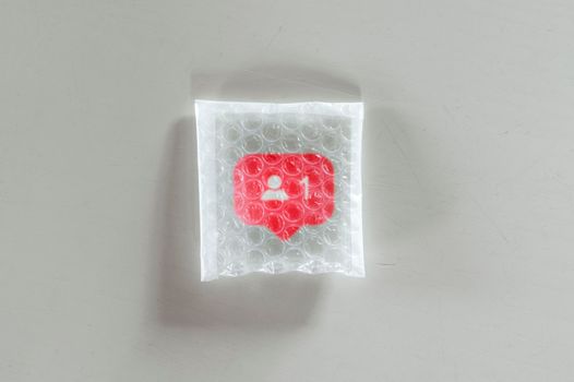 Packaging social symbols and icons with bubble wrap.