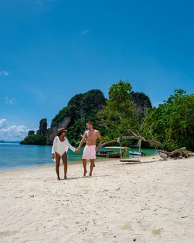 Koh Phakbia Island is near Koh Hong Krabi, a beautiful white sandy beach in Krabi Thailand. Young Asian woman and European men on the beach.