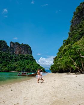 Koh Phakbia Island is near Koh Hong Krabi, a beautiful white sandy beach in Krabi Thailand. Young Asian woman and European men on the beach.