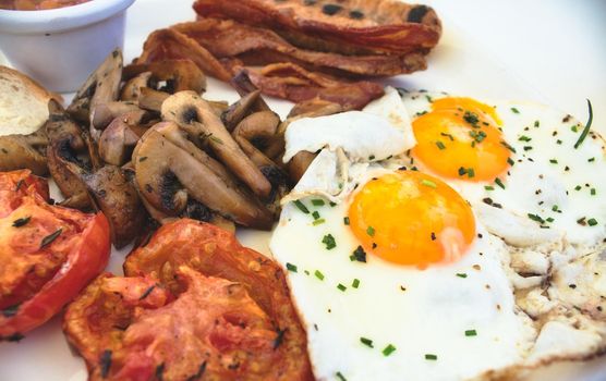 Close-up of full English breakfast on a white plate