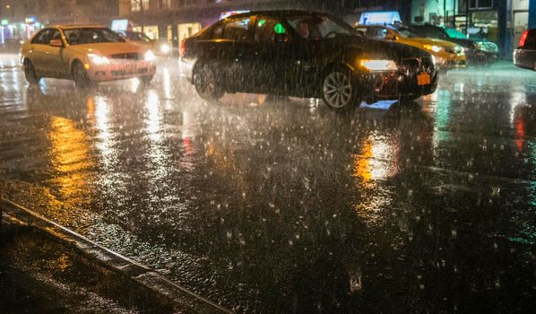 Car driving in Rain in the street.