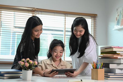 Group of students doing homework together and helping each other at home.