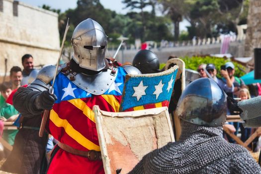 Mdina / Malta - May 4 2019: Men dressed as knights in armor reenacting a battle at a medieval festival