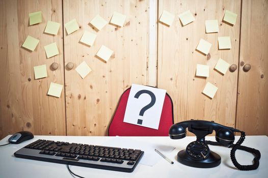 Vacant job desk at office with seat and question mark and computer.