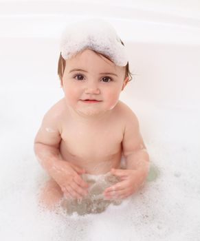 Portrait of a cute baby girl in the bathtub.