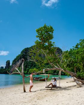 Koh Phakbia Island is near Koh Hong Krabi, a beautiful white sandy beach in Krabi Thailand. Young Asian woman and European men on the beach.