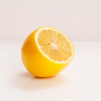 Juicy fresh cut lemon on a white background.