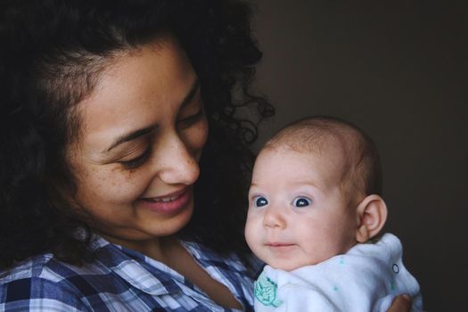 Happy smiling young mother with newborn baby