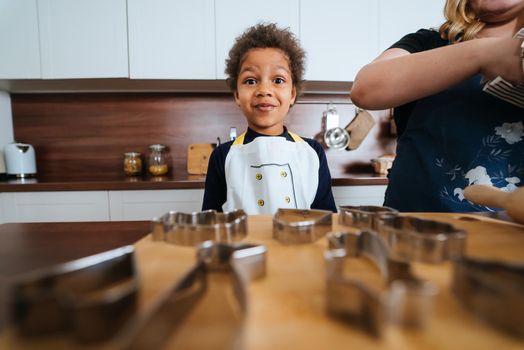 Happy family having fun in the kitchen. Mom teaches her little daughter to cook.