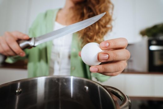 Woman is preparing food in the kitchen. Beating eggs. Cooking At Home. Prepare Food.