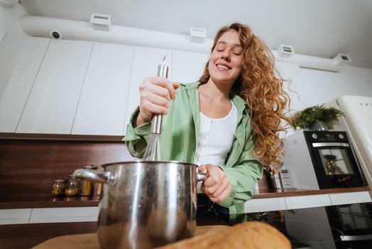 Woman is preparing food in the kitchen. Cooking At Home. Prepare Food.