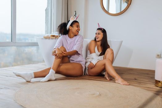 Two girls talking on the bathroom floor