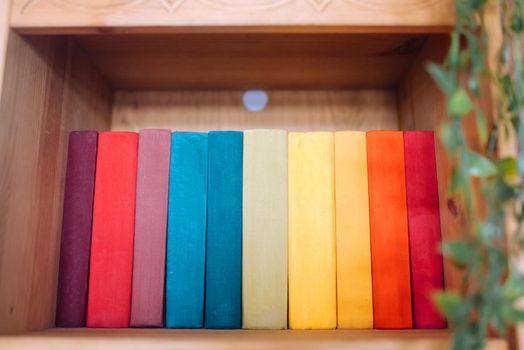 Many books on wooden shelf