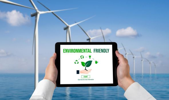 Green business transformation for environment saving and ESG business concept. Businessman using tablet to set corporate goal toward environmental friendly management and alternative clean energy use.