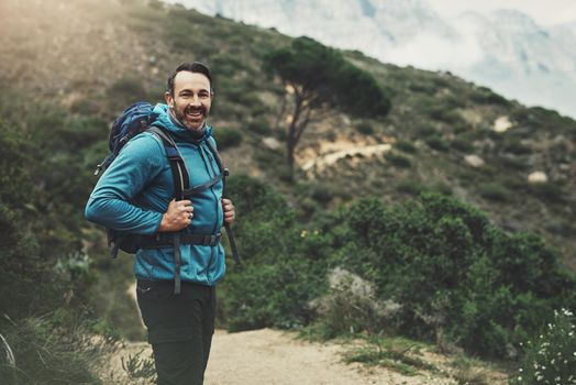 Portrait of a middle aged man hiking in the mountains.