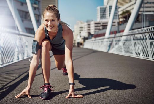 Shot of a sporty young woman getting set for a run.