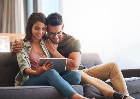 Shot of a young couple using a digital tablet together at home.