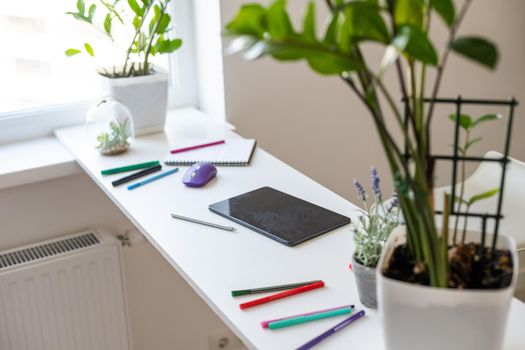 modern digital tablet with pen on a wooden desk.