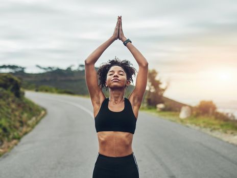 Cropped shot of an attractive young sportswoman meditating during her workout outdoors.