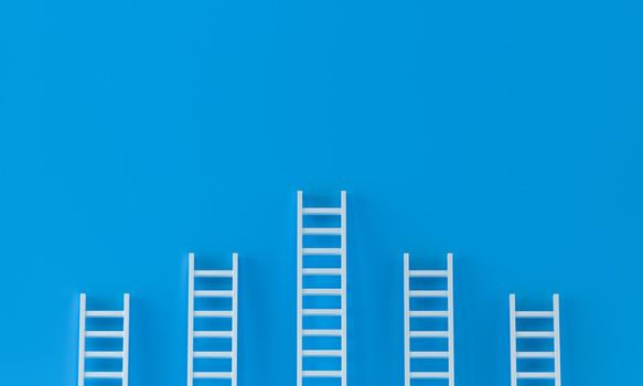 Ladder achievement concept on blue wall studio background. leadership, success concept with copy spaces for text. 3d rendering.