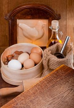 kitchen appliances, products and eggs on wooden table