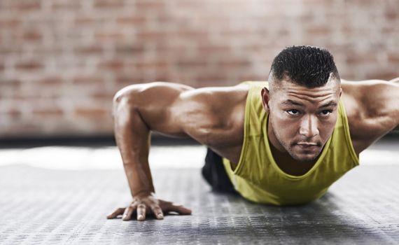 Cropped shot of a young man working out in the gym.