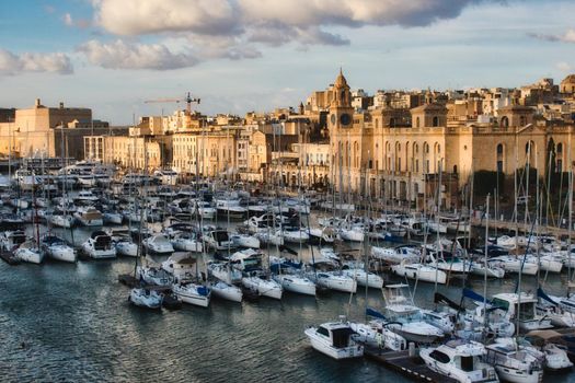 Aerial view of the Birgu waterfront with lots of luxury yachts moored in the marina