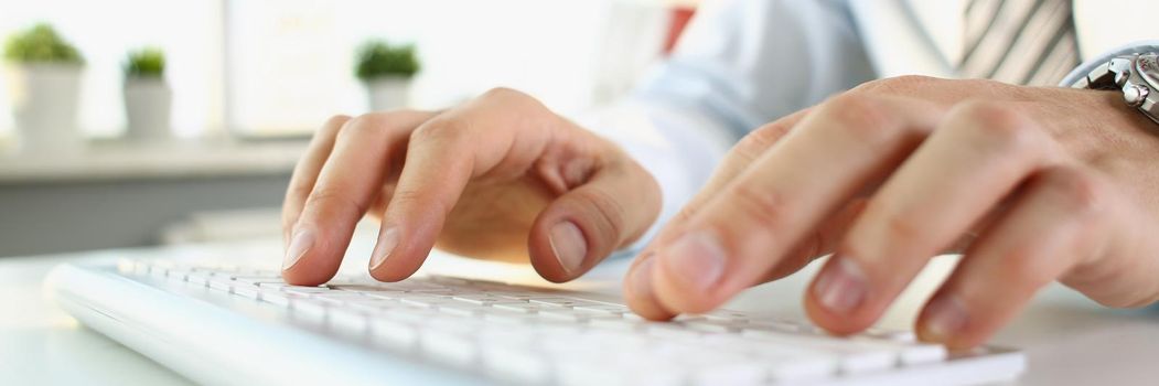 A man is typing on the keyboard, hands close-up, blurry. Office worker workplace, professional blind printing
