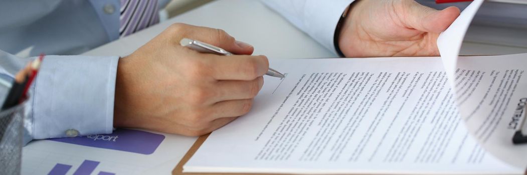 A man in the office signs a contract, close-up. Employment contract, company cooperation, proposal research