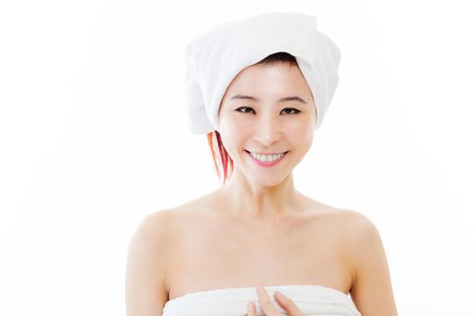 Chinese-American woman wearing a white towel on body and head smiling at camera, isolated, beauty concept