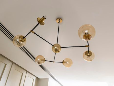 Chandelier for apartment decor on the background of the ceiling