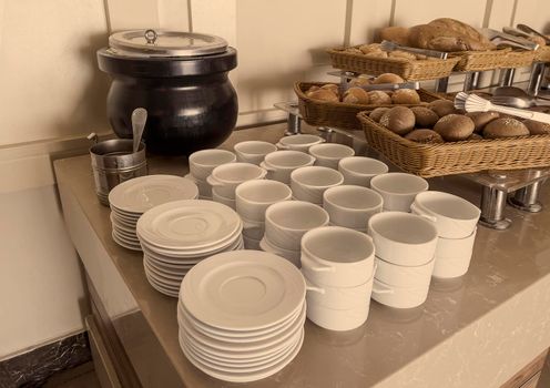 Empty clean dishes for tea or coffee on the table. Top view, pastel vintage tones.