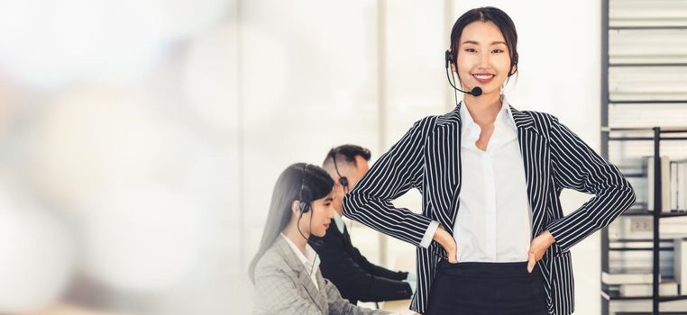 Business people wearing headset working in office to support remote customer or colleague. Call center, telemarketing, customer support agent provide service in broaden view .