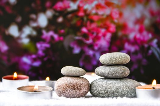 Zen concept, spa pebbles stones and burning aroma candles on blurred background, Treatment aromatherapy and massage, copy space for text