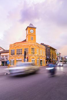 Phuket Thailand , September 14th 2020 ; Landmark chino-portuguese clock tower in phuket old town, Thailand, with light trails on road in twilight time.