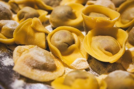 Close-up of fresh pasta tortellini covered in grated parmesan cheese