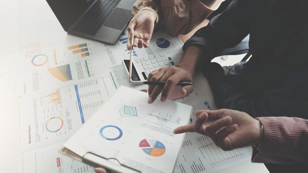 Business People Meeting using laptop computer, calculator,notebook,stock market chart paper for analysis Plans to improve quality next month. Conference Discussion Corporate Concept.