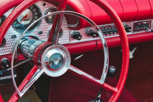 Rabat / Malta - July 24 2019: Close up of red steering wheel inside the cockpit of a Ford Thunderbird classic sports car