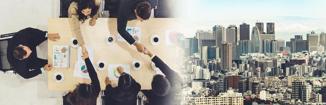 Group business people handshake at meeting table in office together with confident shot from top view . Young businessman and businesswoman workers express agreement of investment deal. broaden view