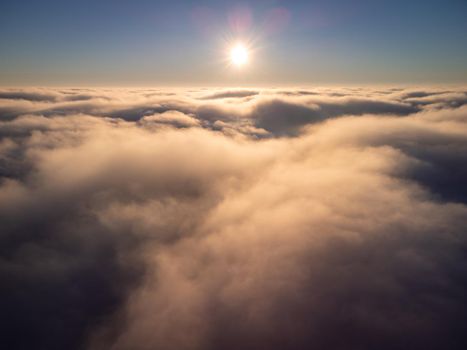Bright aerial photo over the clouds in the evening