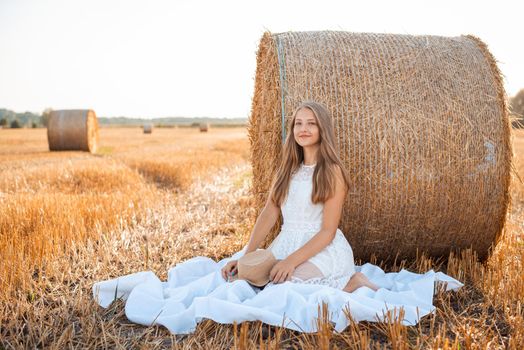 Portrait of a beautiful girl on the agricultural field