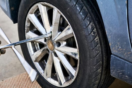Replacing a car wheel at a tire station. a rubber covering, typically inflated or surrounding an inflated inner tube, placed around a wheel to form a flexible contact with the road.