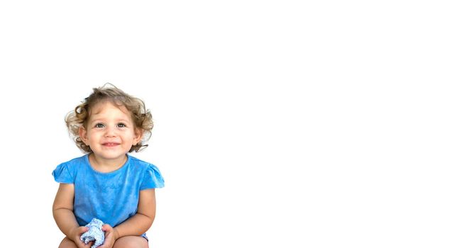 Cute smiling little girl looking thoughtful isolated against a pure white background